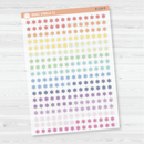 Sheet of asterisk icon planner stickers in rainbow colorways, styled flat lay