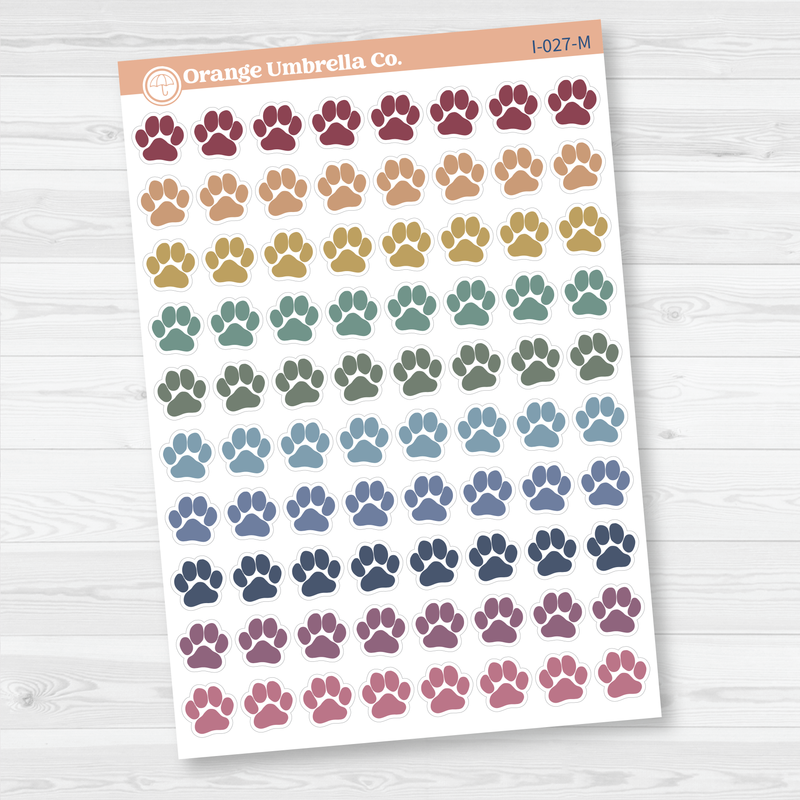 Sheet of colorful paw print stickers by Orange Umbrella Co. on a white background